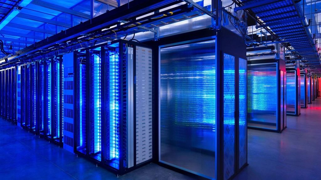 Long aisles of server cabinets lit in blue