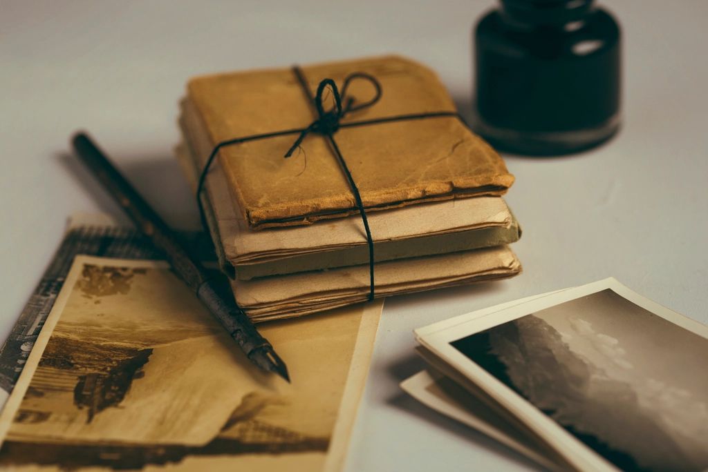 A fountain pen, an ink bottle and a bundle of old letters tied with string