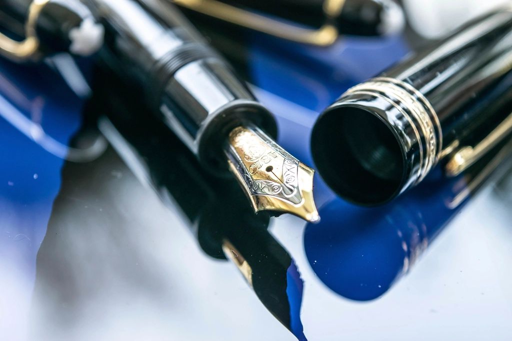 Close view of an open fountain pen and its cap